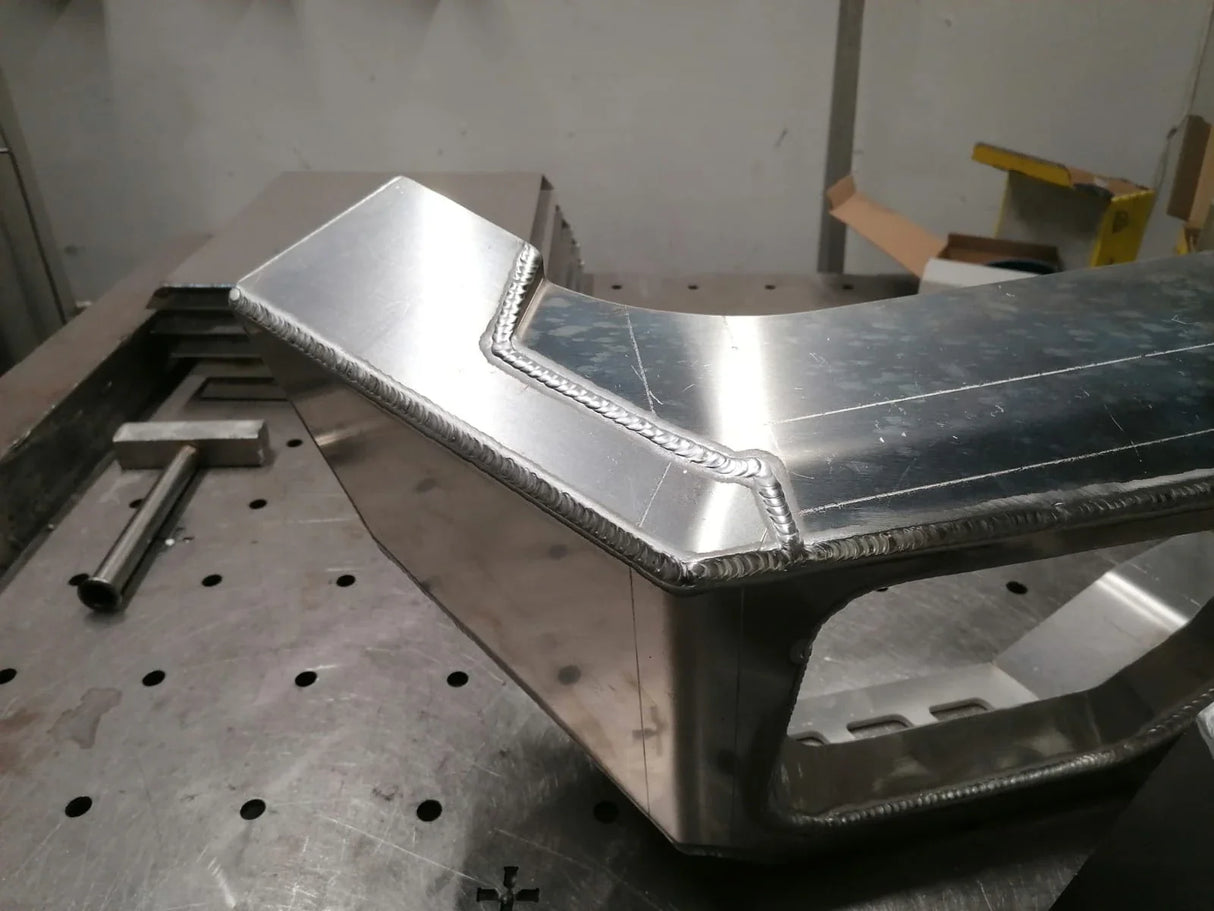Close-up of weld detail on Overland-G aluminum front bumper side section during fabrication