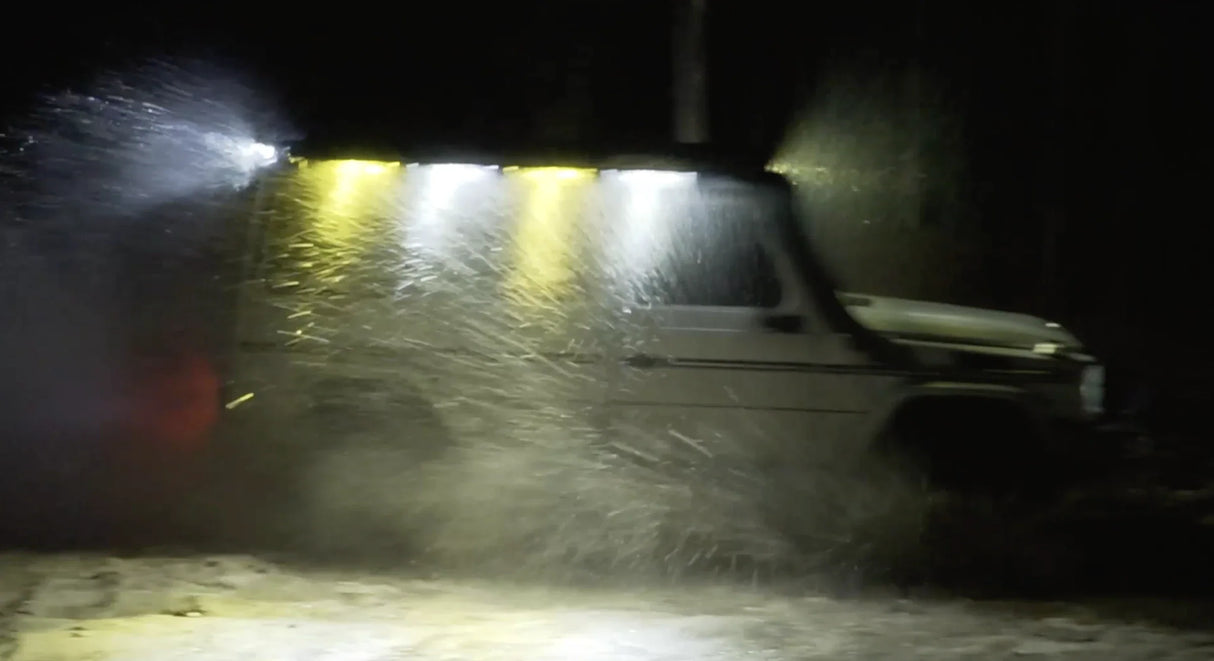 Overland-G perimeter lighting kit illuminated during winter donuts action side view