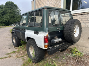 Toyota Land Cruiser 70 1986 SWB green black exterior rear three-quarter view