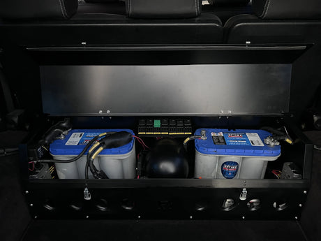 Overland-G dual battery storage box open showing interior battery tray and wiring layout