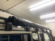 Overland-G expedition roof rack on Mercedes-Benz G-Class with side awning deployed